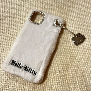 Hello kitty white fuzzy case with a dangling hello kitty charm!